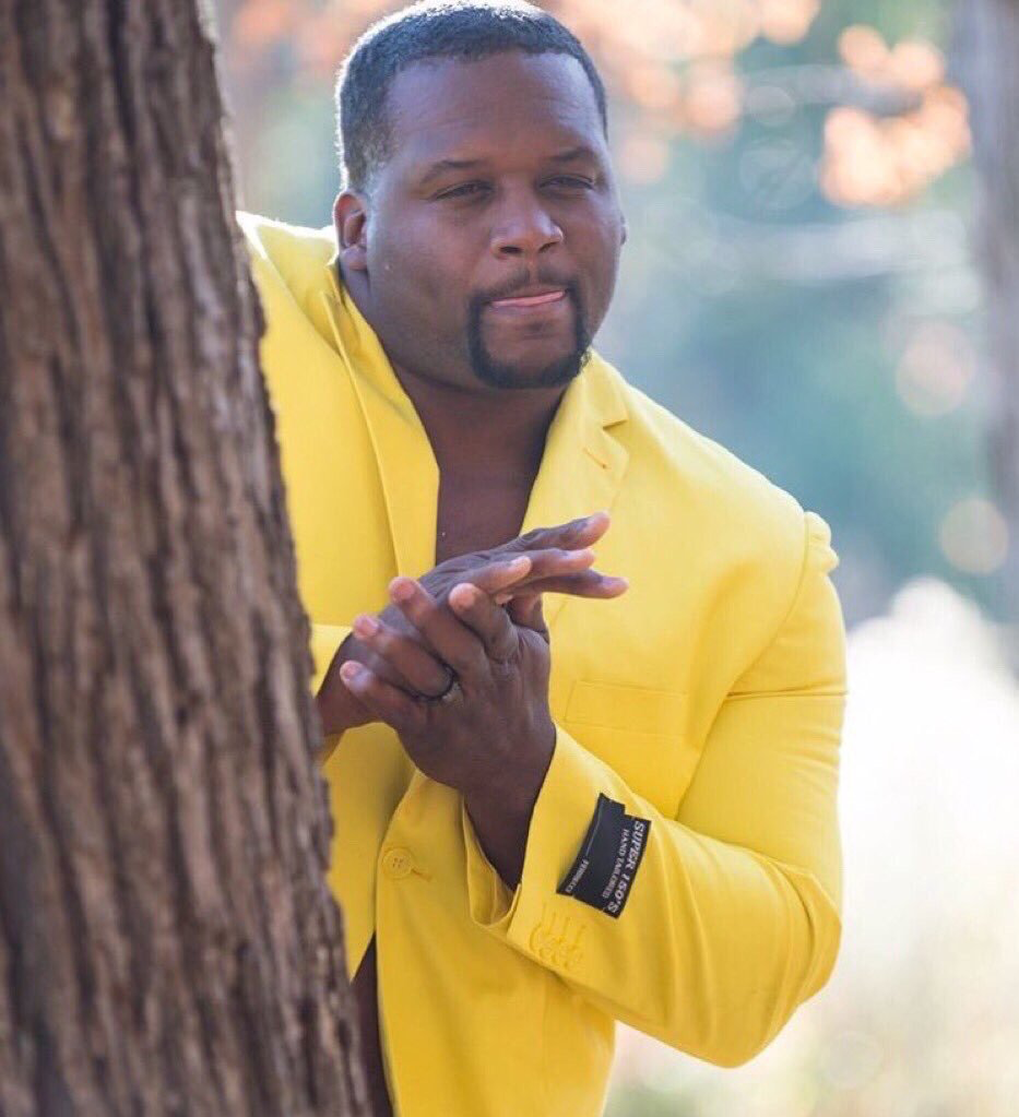 Black guy hiding behind tree